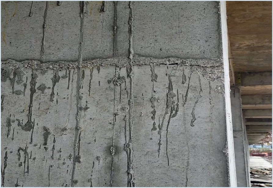 Horizontal construction joint visible in an unfinished concrete wall